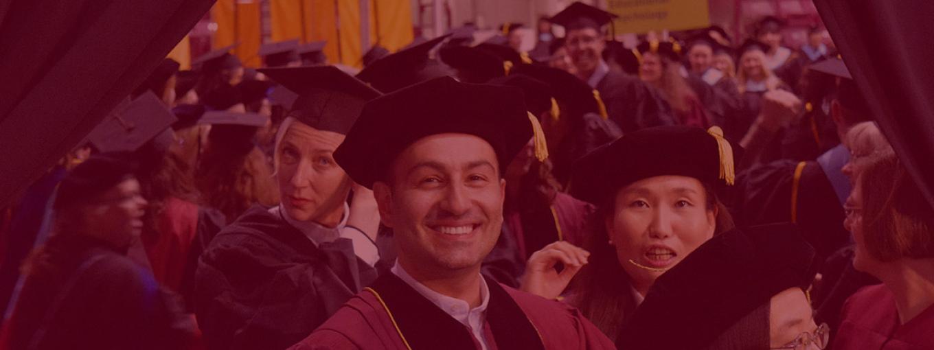 faculty members smiling for a photo at graduation